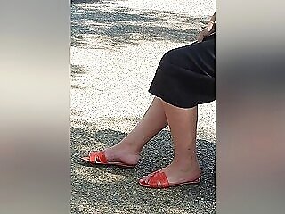 Candid Gams And Feet In Orange Sandals Of A Brown-haired Woman At The Bus